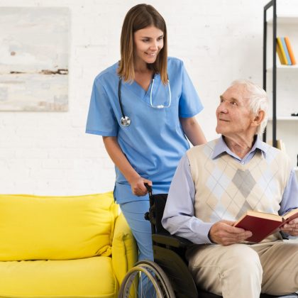 old-man-sitting-on-wheelchair-while-talking-to-nurse